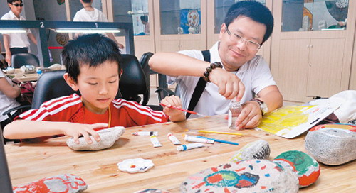 Visitors Having Fun in the Magic Stone Paradise by Painting Stones Visitors Having Fun in the Magic Stone Paradise by Painting Stones